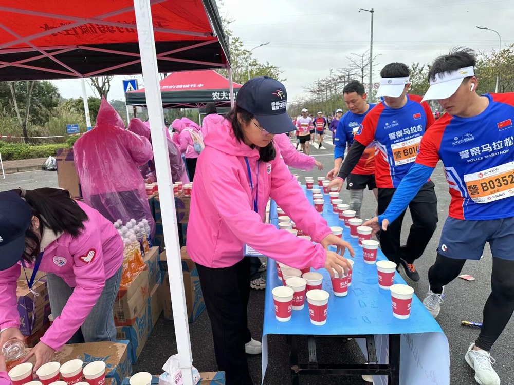 志愿者为运动员分发补给